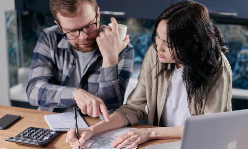 Man and woman looking at a bill